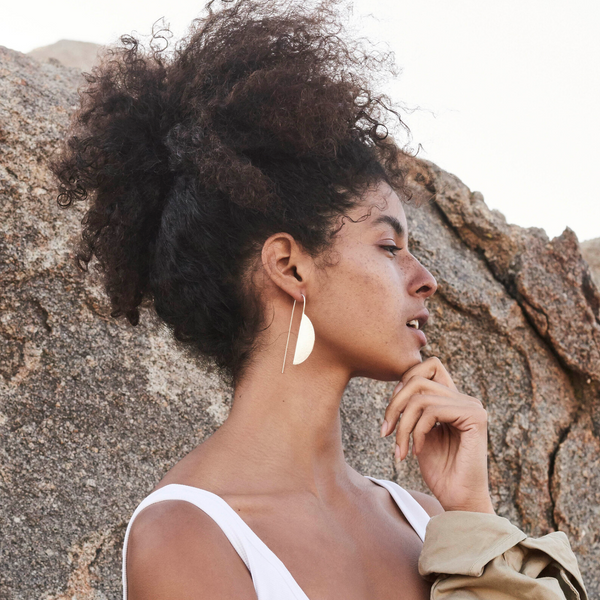 Premium Photo | A woman with long curly hair and earrings